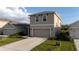 Exterior view of a two-story home with a driveway and two-car garage, landscaped for curb appeal at 4907 Wedgeleaf Way, Palmetto, FL 34221