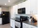 Well-equipped kitchen with stainless steel appliances, granite countertops, and ample storage space at 4907 Wedgeleaf Way, Palmetto, FL 34221