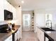 Modern kitchen featuring granite countertops, white cabinets, stainless steel appliances, and contemporary fixtures at 4907 Wedgeleaf Way, Palmetto, FL 34221