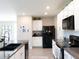 Spacious kitchen boasts granite countertops, white cabinets, stainless steel appliances, and stylish backsplash at 4907 Wedgeleaf Way, Palmetto, FL 34221