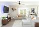 Comfortable living room with a large sectional sofa, ceiling fan, and a wall-mounted television at 4907 Wedgeleaf Way, Palmetto, FL 34221