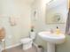 Stylish powder room with a pedestal sink, and tasteful decor at 4907 Wedgeleaf Way, Palmetto, FL 34221