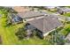 Expansive backyard features a screened in lanai, mature landscaping, and private pool at 5384 Layton Dr, Venice, FL 34293