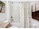 Bathroom featuring a shower-tub combination with a tropical-themed curtain at 5384 Layton Dr, Venice, FL 34293