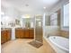 Bathroom features a soaking tub and tiled shower at 5384 Layton Dr, Venice, FL 34293