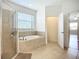 Bathroom features a soaking tub and tiled shower at 5384 Layton Dr, Venice, FL 34293