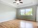 Bright bedroom features wood floors and a large window overlooking the yard at 5384 Layton Dr, Venice, FL 34293