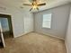 Neutral bedroom with plush carpet, ceiling fan, and closet at 5384 Layton Dr, Venice, FL 34293