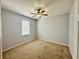 A clean bedroom featuring neutral walls and a bright window at 5384 Layton Dr, Venice, FL 34293