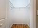 A walk-in closet with wood floors and built-in shelving at 5384 Layton Dr, Venice, FL 34293