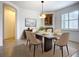 Dining room with a modern table set, arched entryway, and decorative lighting at 5384 Layton Dr, Venice, FL 34293