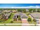 Well-manicured single-Gathering home featuring a two-car garage, brick driveway, and lush landscaping at 5384 Layton Dr, Venice, FL 34293
