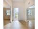 Bright foyer featuring neutral tile flooring, an open floor plan, and ample natural light through large windows at 5384 Layton Dr, Venice, FL 34293