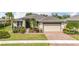 Charming single-story home featuring a two-car garage, mature landscaping, and a welcoming entryway at 5384 Layton Dr, Venice, FL 34293