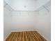 A walk-in closet with wood floors and built-in shelving at 5384 Layton Dr, Venice, FL 34293