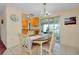 Charming dining area with chandelier and slider to the Florida room, adjacent to the kitchen at 595 Circlewood Dr # Y4, Venice, FL 34293