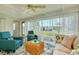 Relaxing Florida room with bright furniture, ceiling fan, and views of the backyard at 595 Circlewood Dr # Y4, Venice, FL 34293