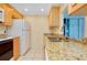 Well-equipped kitchen featuring granite countertops and stainless steel sink at 595 Circlewood Dr # Y4, Venice, FL 34293