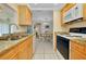 A bright and airy kitchen, featuring a view of the dining room, appliances, and stone countertops at 595 Circlewood Dr # Y4, Venice, FL 34293