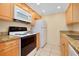 Well-lit kitchen featuring modern appliances and a white microwave oven at 595 Circlewood Dr # Y4, Venice, FL 34293