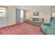 Inviting living room featuring comfortable seating and view of door and window with floral curtains at 595 Circlewood Dr # Y4, Venice, FL 34293
