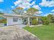 Charming home with a covered patio, lush landscaping, and a well-maintained lawn, perfect for enjoying the outdoors at 810 Channel Acres Rd, Nokomis, FL 34275