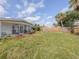 Expansive backyard with a lawn and screen-enclosed lanai, perfect for enjoying the outdoors at 8132 Coco Solo Ave, North Port, FL 34287