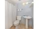 Simple bathroom featuring a pedestal sink and stand up shower with white tile at 8132 Coco Solo Ave, North Port, FL 34287