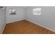 Small bedroom with hardwood floors, two windows, and neutral wall color at 8132 Coco Solo Ave, North Port, FL 34287