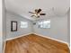 Simple bedroom with wood flooring, windows, and a ceiling fan at 8132 Coco Solo Ave, North Port, FL 34287