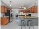 Well-lit kitchen with stainless steel appliances and granite countertops, open to the outdoor space at 8132 Coco Solo Ave, North Port, FL 34287