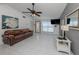 Bright living room with tile floors, a leather couch, and a view towards the front entrance at 8132 Coco Solo Ave, North Port, FL 34287