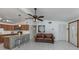 Cozy living area flowing into a kitchen with stainless steel stools and a granite countertop at 8132 Coco Solo Ave, North Port, FL 34287
