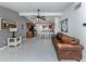Bright, open-concept living space with tile floors seamlessly connecting to the modern kitchen at 8132 Coco Solo Ave, North Port, FL 34287