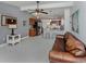 Bright, open-concept living space with tile floors seamlessly connecting to the modern kitchen at 8132 Coco Solo Ave, North Port, FL 34287