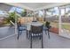 Screened-in patio with table and chairs, views of the backyard and landscaping at 8132 Coco Solo Ave, North Port, FL 34287