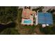 Overhead view showcasing the pool, tennis courts, and clubhouse within a community setting at 8300 Parkside Dr, Englewood, FL 34224