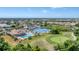 Aerial view of a pool, clubhouse, tennis courts and golf course in a planned community at 8300 Parkside Dr, Englewood, FL 34224