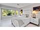 A calming bedroom with a large window showcasing a lush green view at 8300 Parkside Dr, Englewood, FL 34224