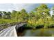 Picturesque boardwalk amidst lush greenery and tranquil waterway at 8300 Parkside Dr, Englewood, FL 34224