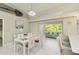 Bright dining area with a modern chandelier and sight lines into the living room and outdoor views at 8300 Parkside Dr, Englewood, FL 34224