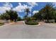 View of the community entrance, showcasing meticulously landscaped grounds and secure gates at 8300 Parkside Dr, Englewood, FL 34224