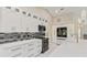 Modern kitchen boasts sleek white cabinetry, stainless steel appliances, and stylish backsplash at 8300 Parkside Dr, Englewood, FL 34224