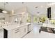 Modern kitchen with white cabinets, sleek countertops, stainless steel appliances, and an open design at 8300 Parkside Dr, Englewood, FL 34224