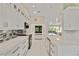 Bright, modern kitchen featuring white cabinetry, stainless steel appliances, and a stylish backsplash at 8300 Parkside Dr, Englewood, FL 34224