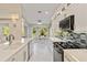 Bright kitchen featuring white cabinets, stainless steel appliances, and a cozy breakfast nook at 8300 Parkside Dr, Englewood, FL 34224