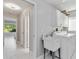 Bright laundry room with a utility sink, and a washing machine and dryer at 8300 Parkside Dr, Englewood, FL 34224