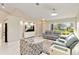 This home features a bright, open living area with tile floors, gray leather sofas and lots of natural light at 8300 Parkside Dr, Englewood, FL 34224