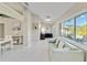 Open-concept living room with large windows overlooking the pool, adjacent to an office at 8300 Parkside Dr, Englewood, FL 34224