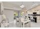 This bright living space features an open concept to the dining and kitchen area with modern white finishes at 8300 Parkside Dr, Englewood, FL 34224